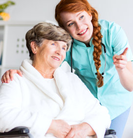 a caregiver woman pointing with an elderly woman